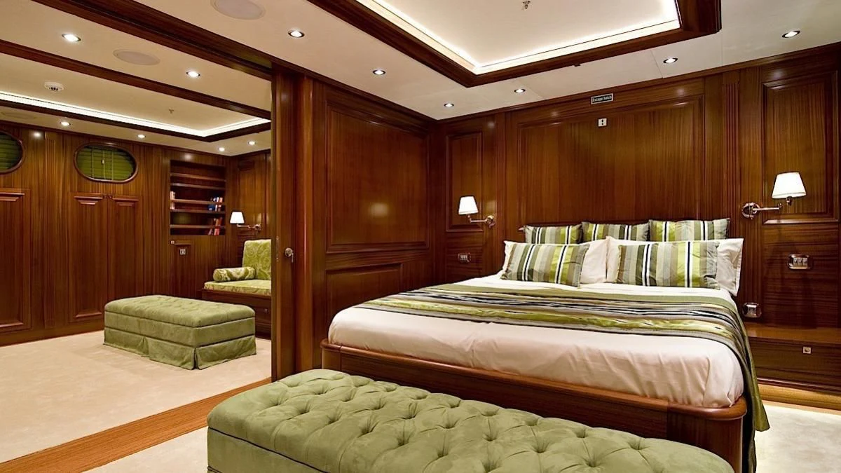 a room with a bed and a chair aboard CLEAR EYES Yacht for Sale