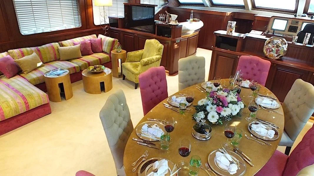 a dining room with a table and chairs aboard CLEAR EYES Yacht for Sale