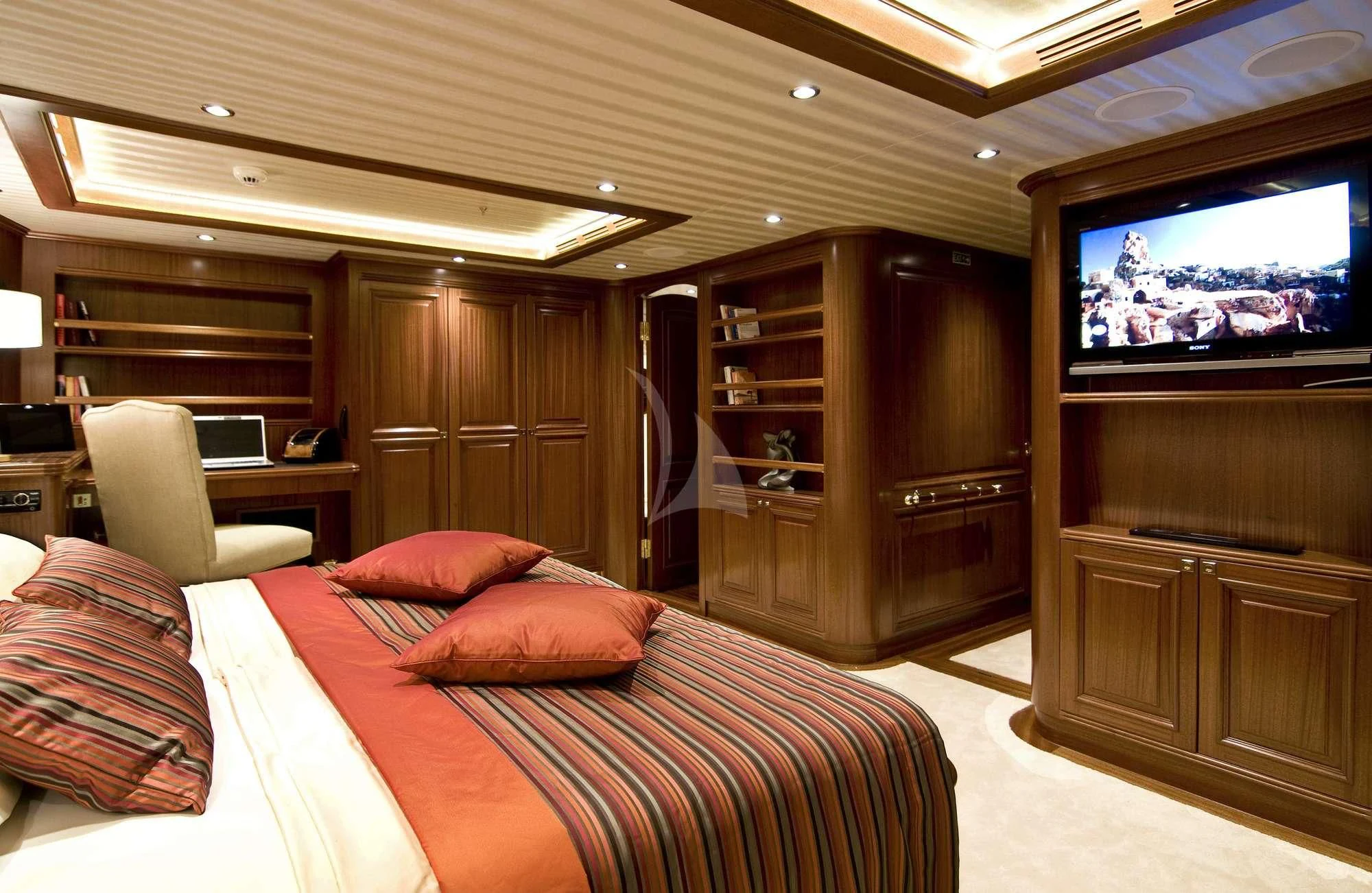 a bedroom with a tv and a bed aboard CLEAR EYES Yacht for Sale