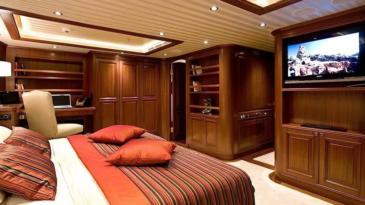 a bedroom with a tv and a bed aboard CLEAR EYES Yacht for Sale