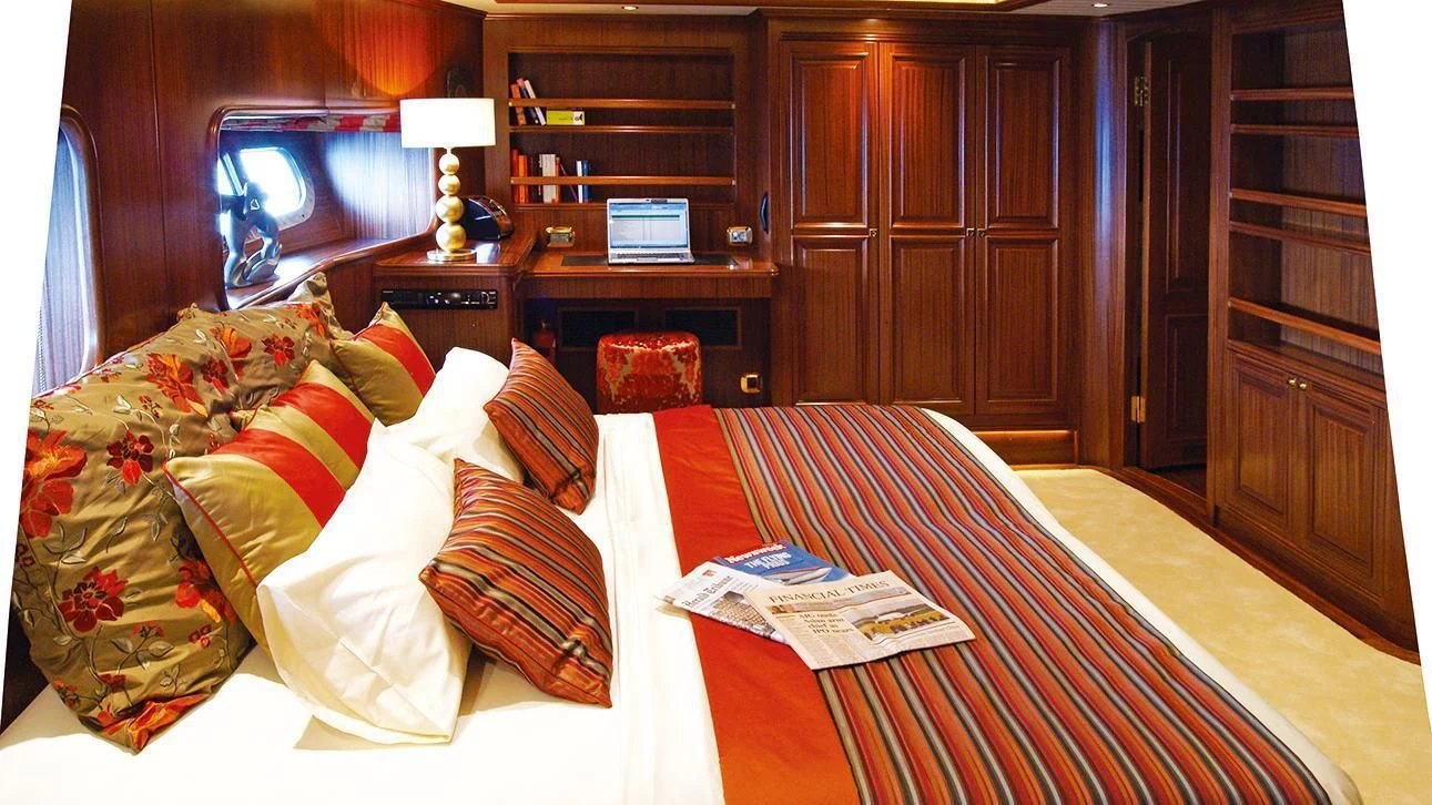 a bedroom with a bed and a desk aboard CLEAR EYES Yacht for Sale