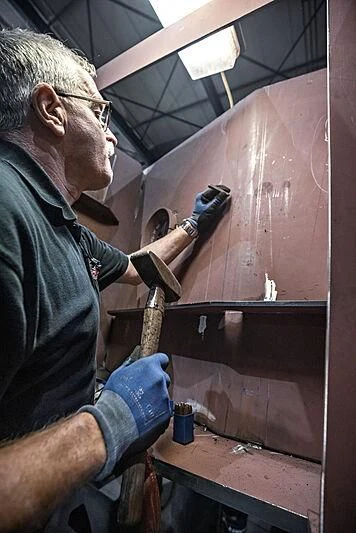 a man working in a factory aboard IRIS BLUE Yacht for Sale