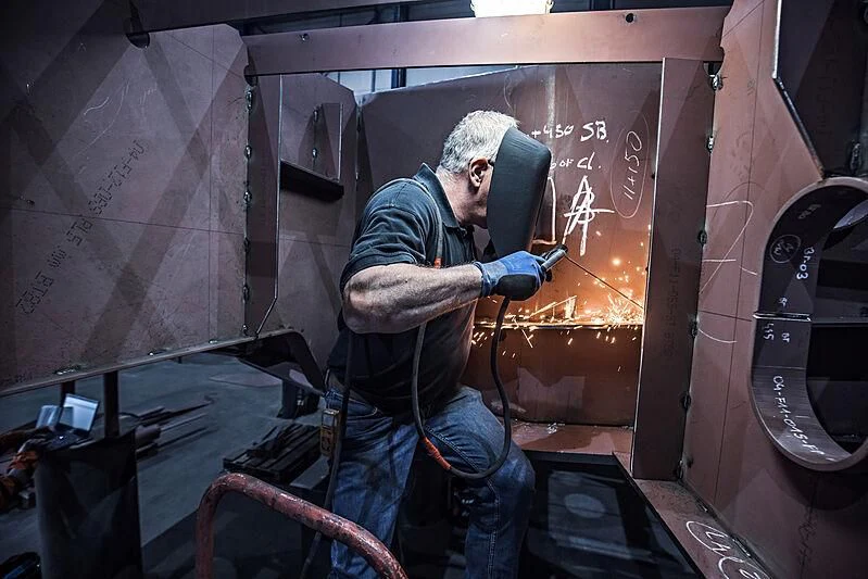 a man working in a factory aboard IRIS BLUE Yacht for Sale