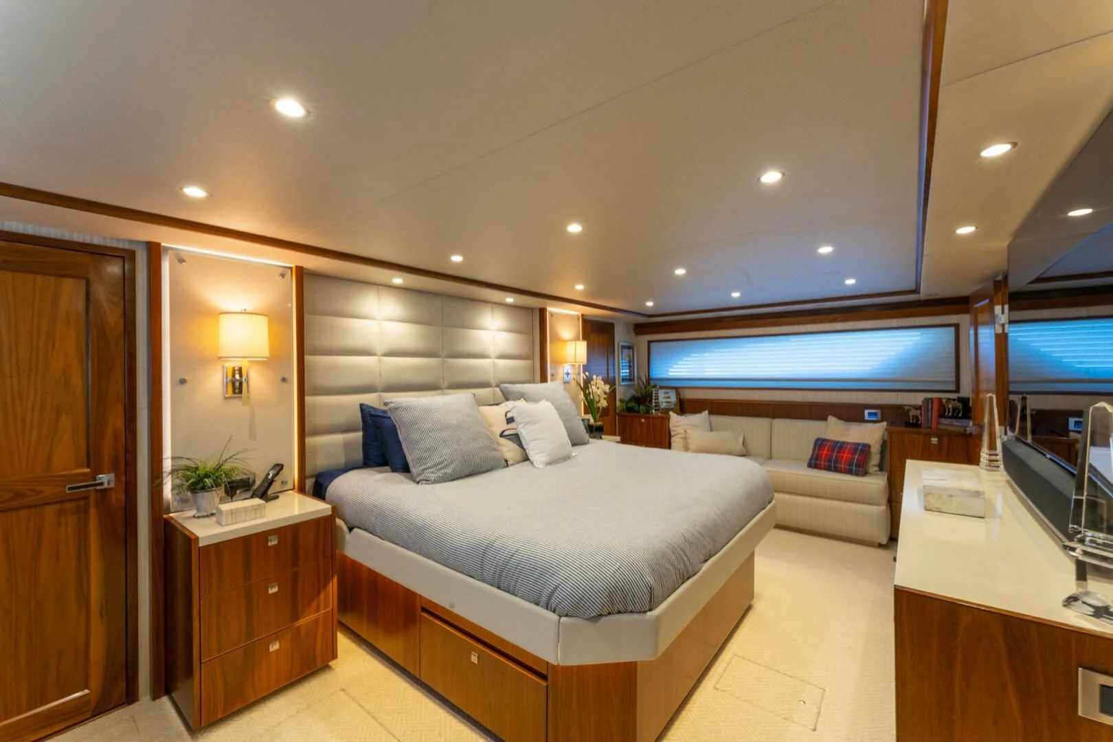 a bedroom with a bed and a tv aboard HIGH COTTON Yacht for Sale