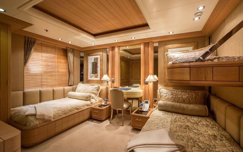 a bedroom with a bed and a couch aboard HARMONY Yacht for Sale