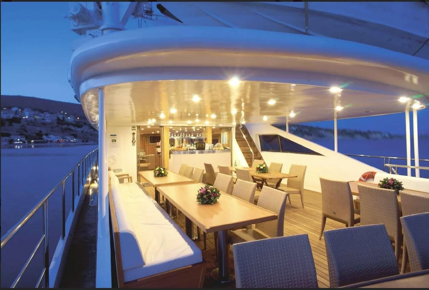 a large room with tables and chairs aboard HARMONY Yacht for Sale