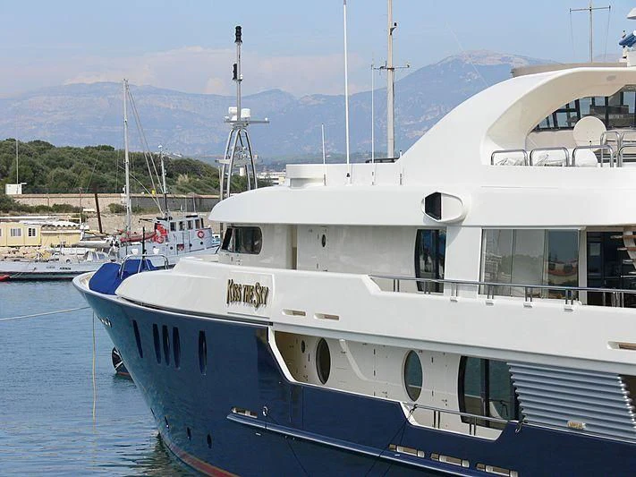 a large white boat in a harbor aboard HARMONY Yacht for Sale