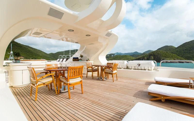 a room with a table and chairs aboard HARMONY Yacht for Sale