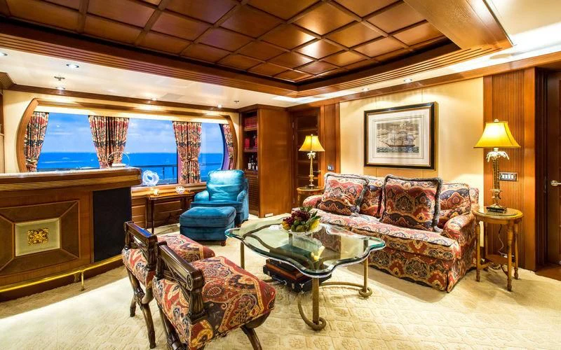 a living room with a fireplace aboard HARMONY Yacht for Sale