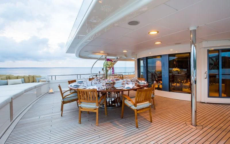 a large room with tables and chairs aboard HARMONY Yacht for Sale