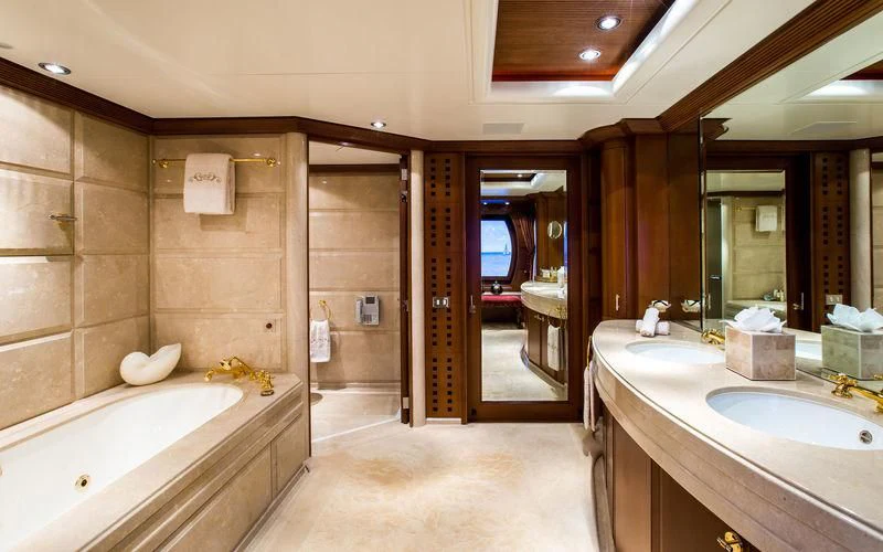 a bathroom with a tub sink and a shower unit aboard HARMONY Yacht for Sale