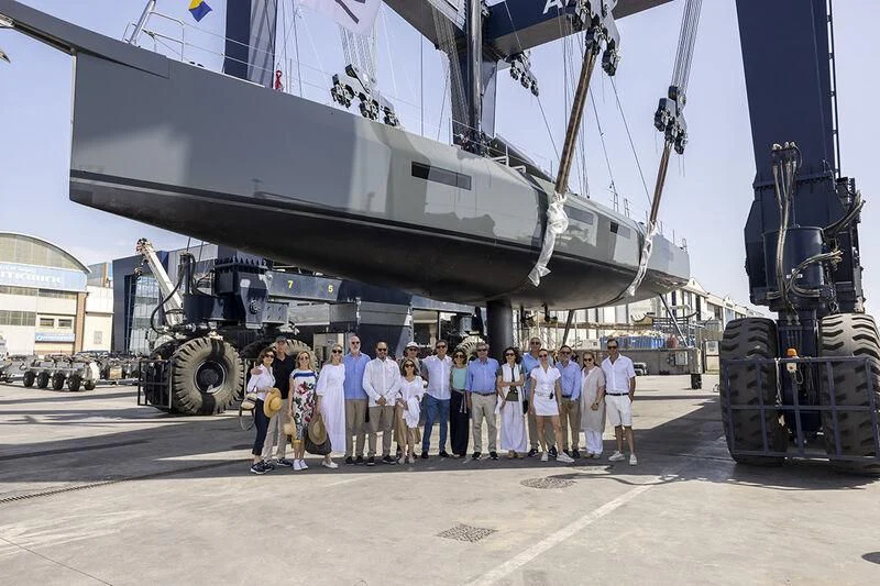 a group of people posing for a photo in front of a large tank aboard MOKA III Yacht for Sale