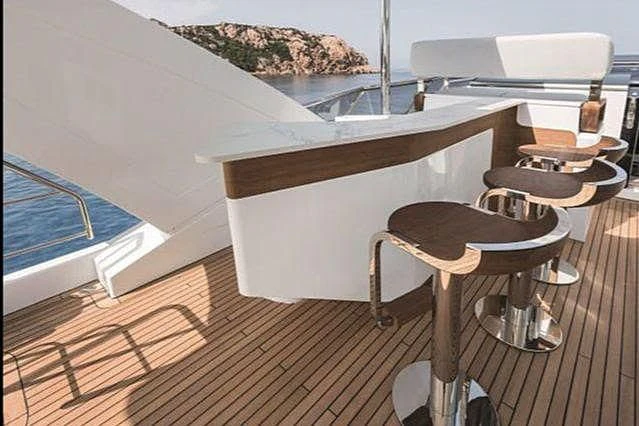 a wooden table and chairs on a deck aboard R.DARENBEN Yacht for Sale