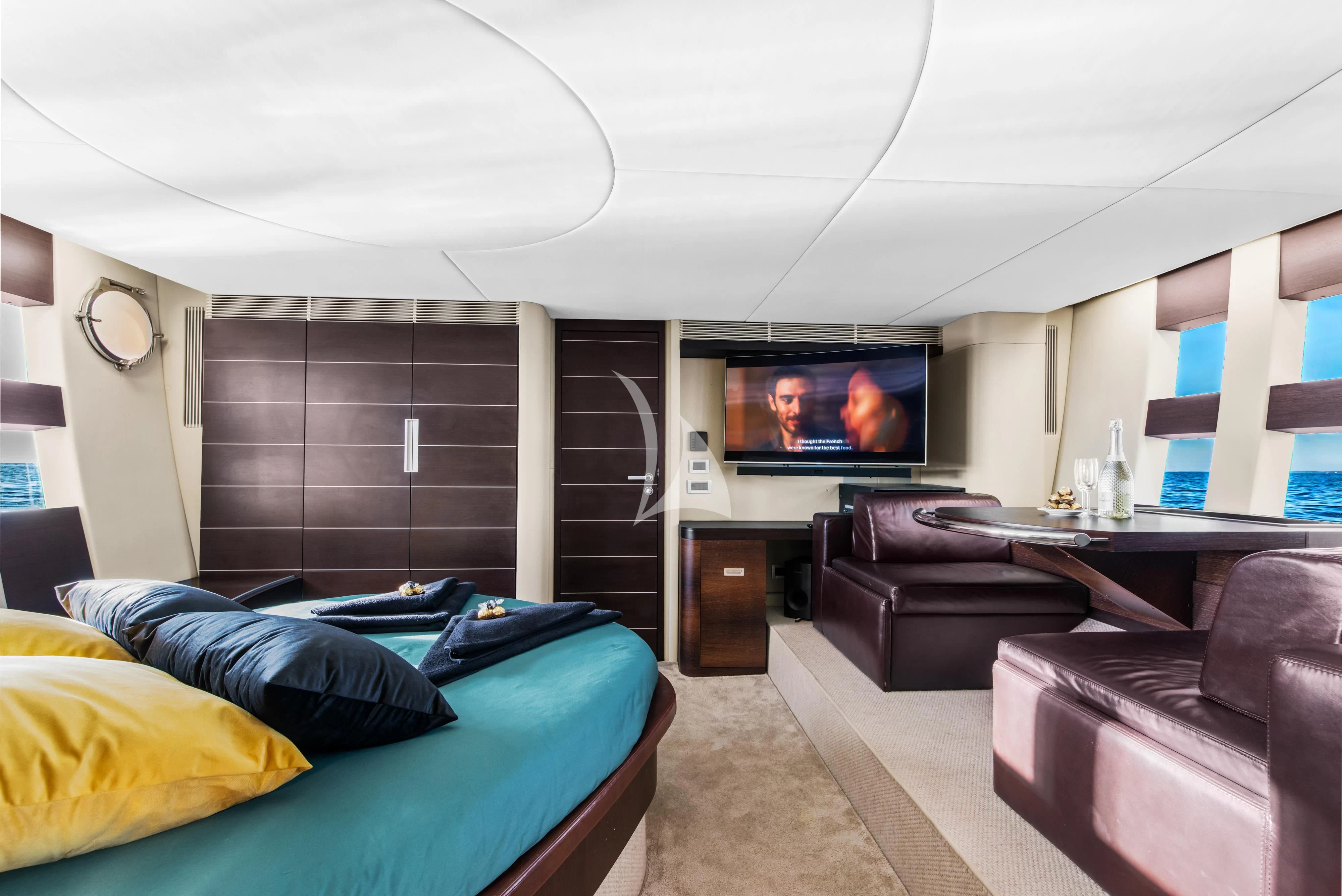 a living room with a tv and couches aboard FALCH Yacht for Charter
