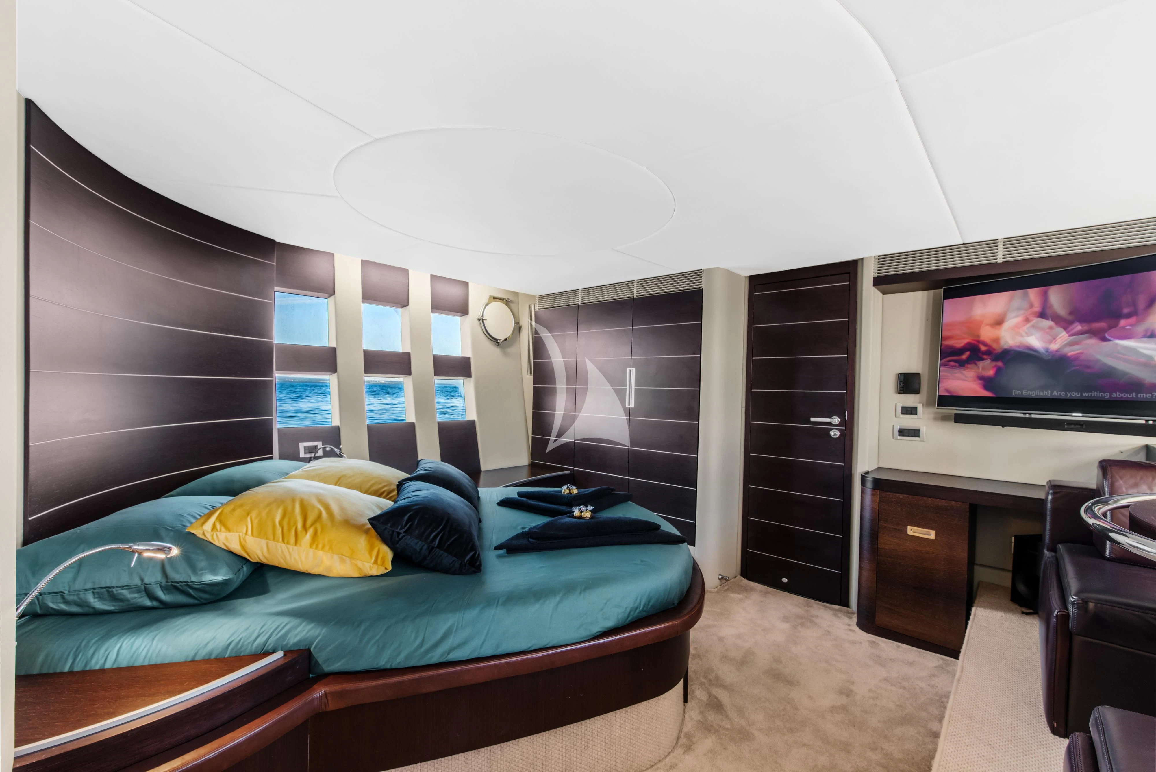 a bedroom with a bed and a television aboard FALCH Yacht for Charter