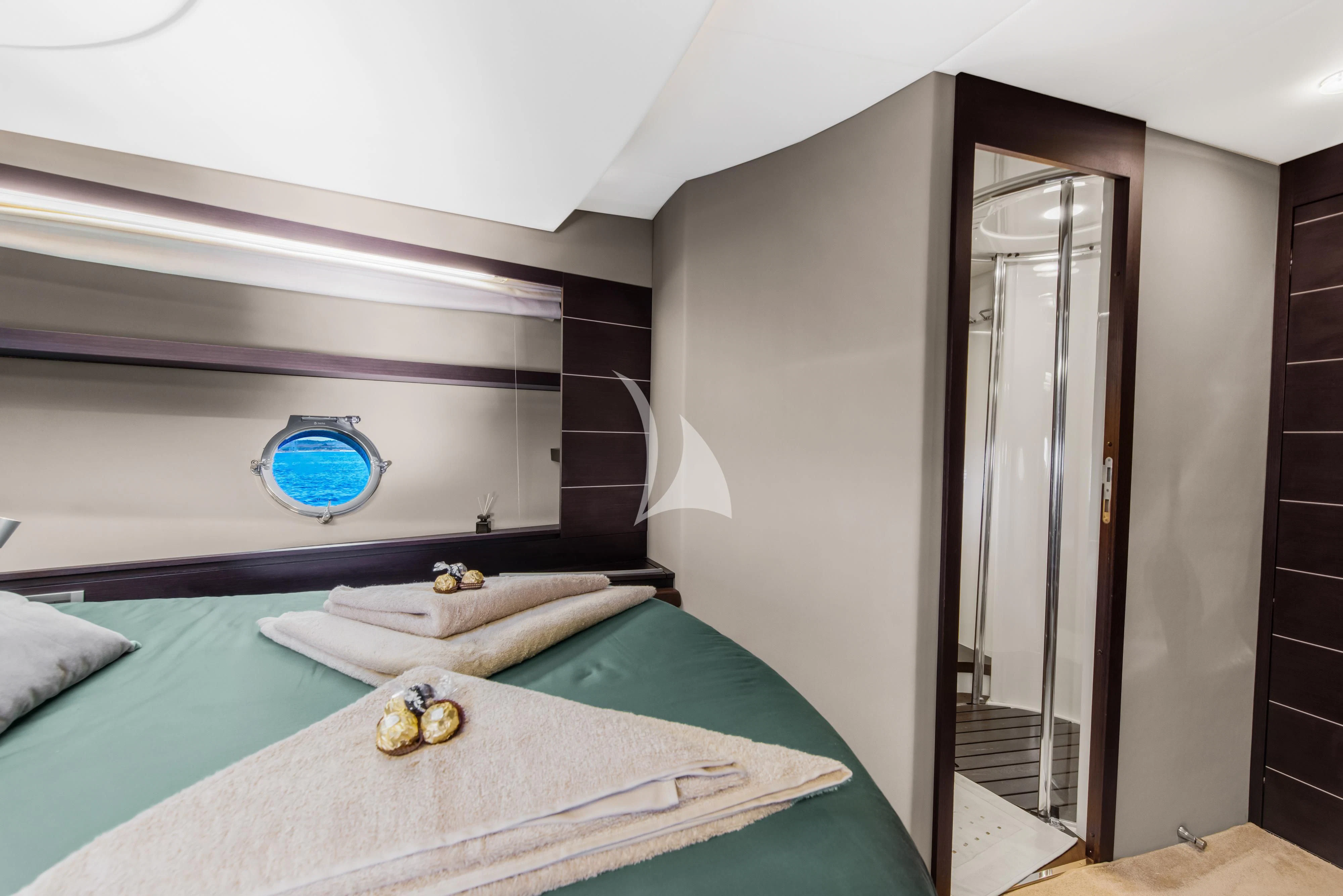 a bedroom with a bed and a mirror aboard FALCH Yacht for Charter