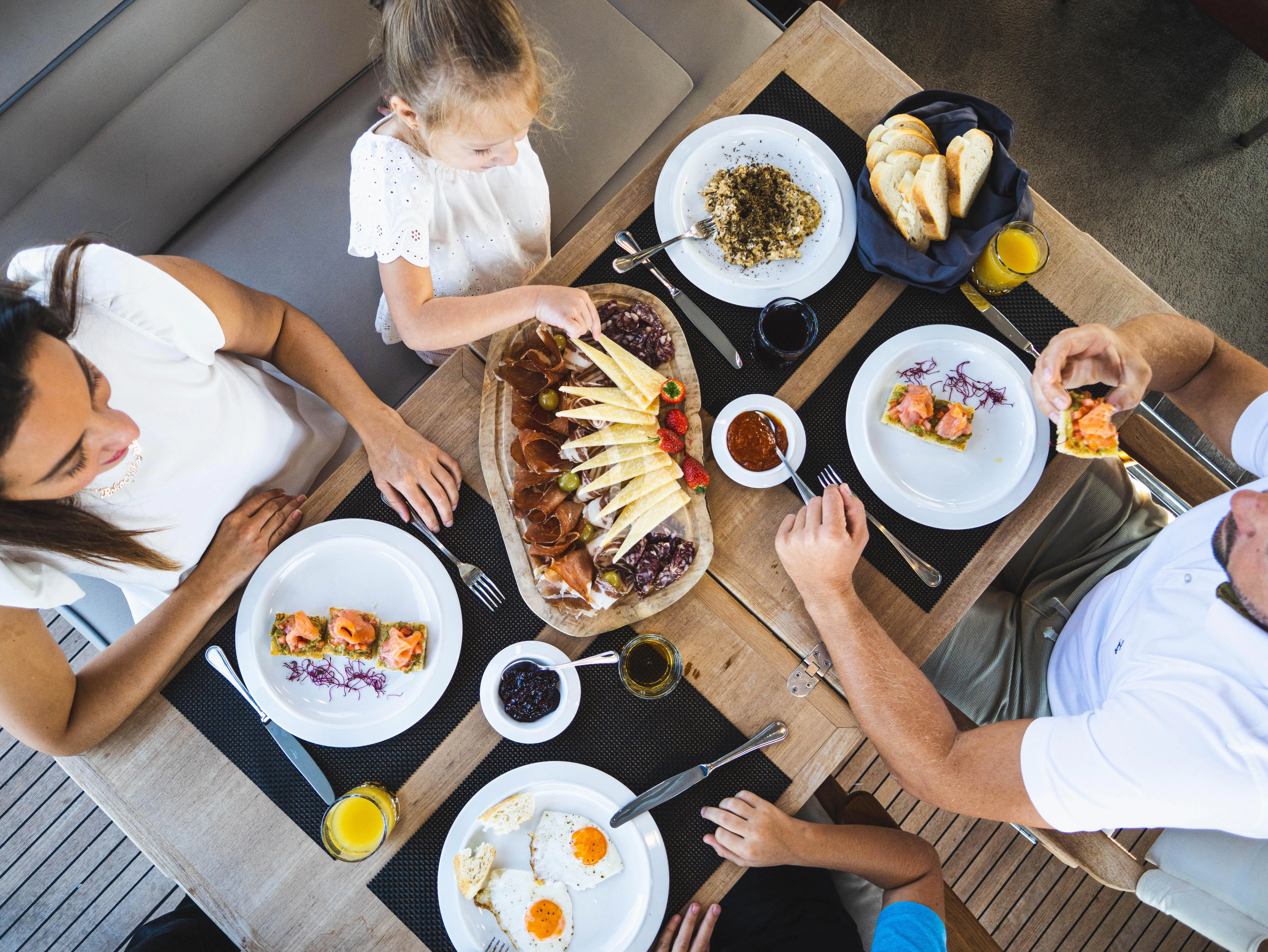 a group of people eating food aboard FALCH Yacht for Charter