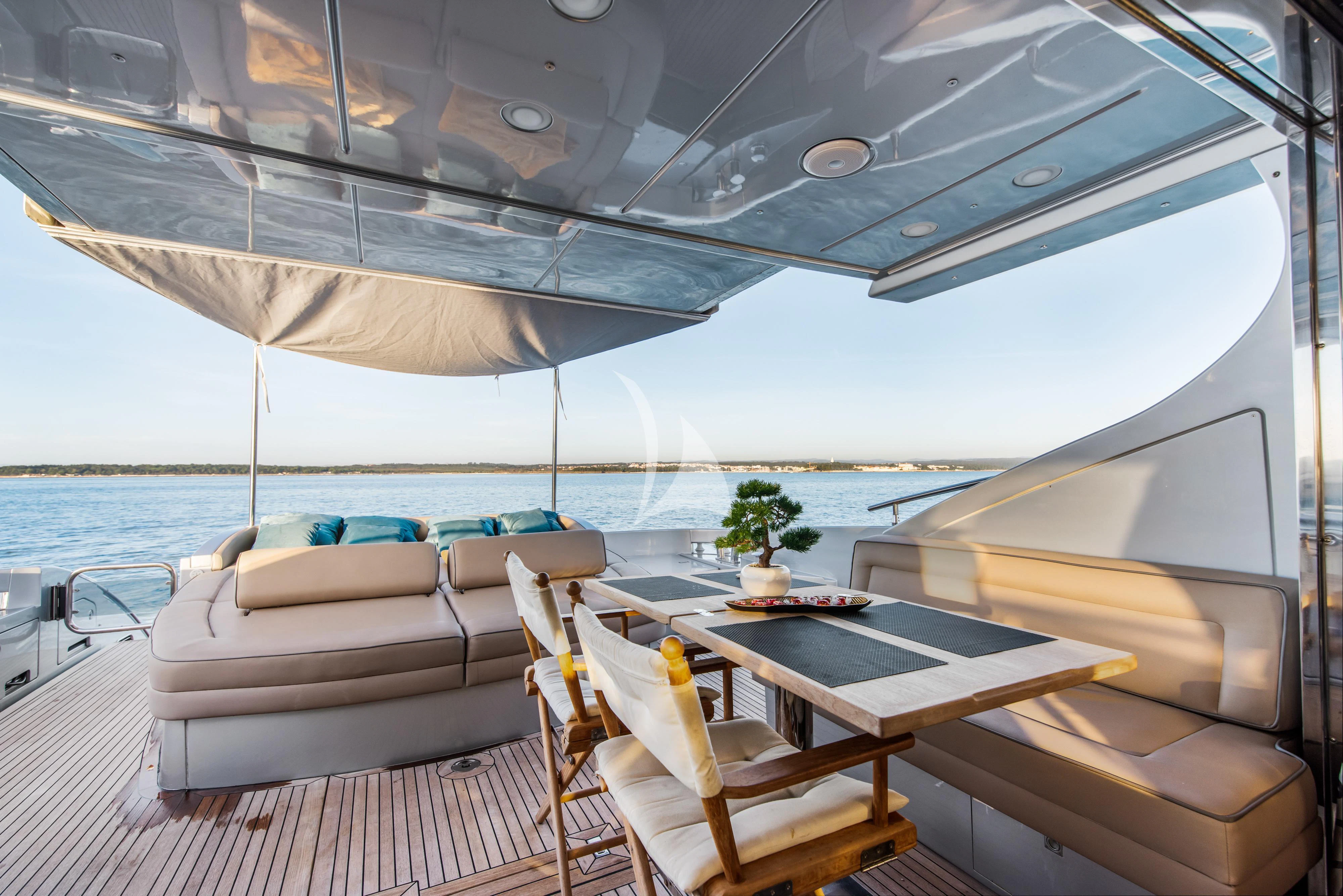 a boat with a table and chairs on the deck aboard FALCH Yacht for Charter