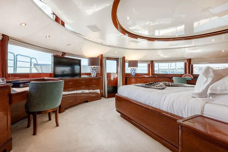 a bedroom with a bed and desk aboard CHECKMATE Yacht for Charter