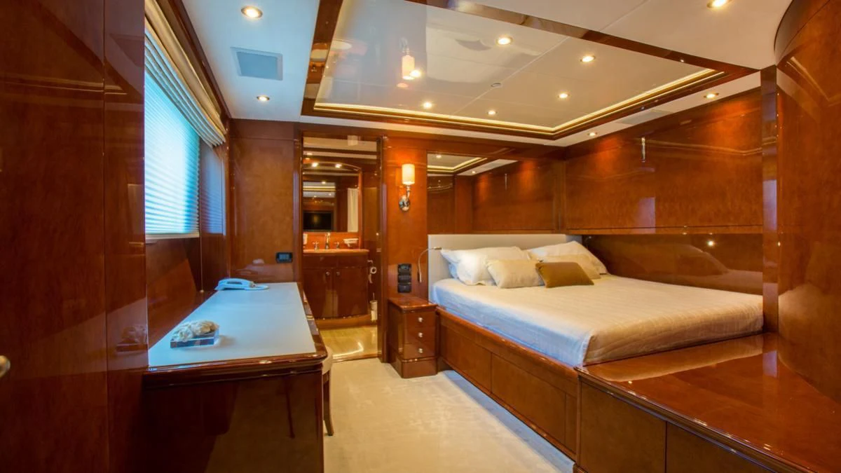 a room with a bed and a desk aboard CHECKMATE Yacht for Charter