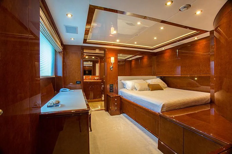 a room with a bed and desk aboard CHECKMATE Yacht for Charter