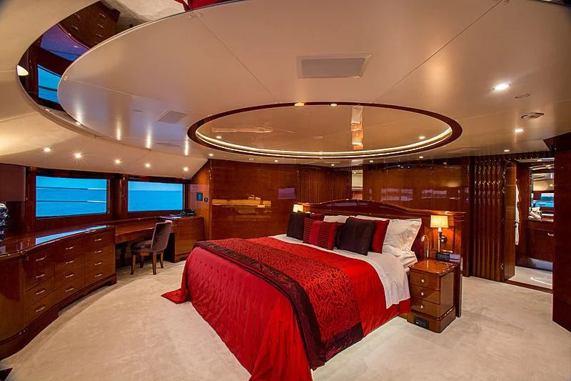a room with a bed and a tv aboard CHECKMATE Yacht for Charter
