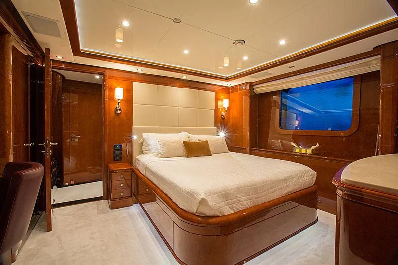 a hotel room with a bed and tv aboard CHECKMATE Yacht for Charter