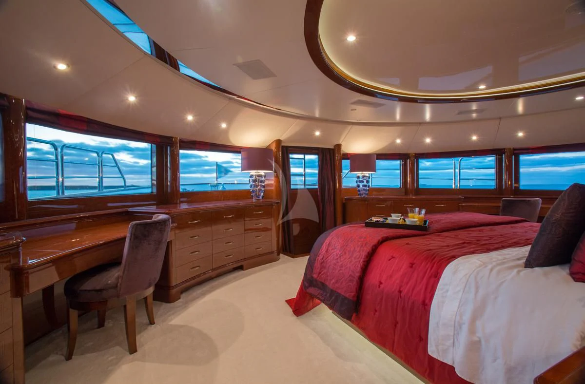 a bedroom with a desk and a bed aboard CHECKMATE Yacht for Charter