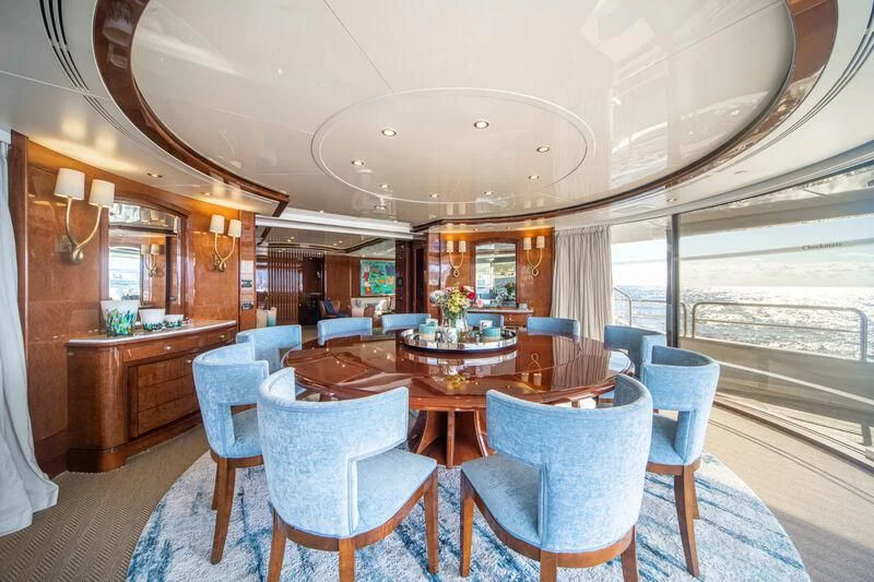 a dining room with a large window aboard CHECKMATE Yacht for Charter