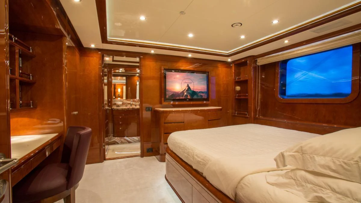 a room with a bed and a tv aboard CHECKMATE Yacht for Charter