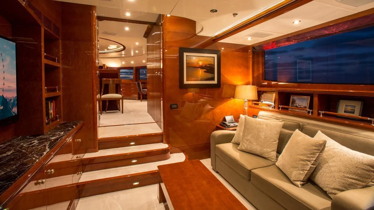 a room with a couch and a piano aboard CHECKMATE Yacht for Charter
