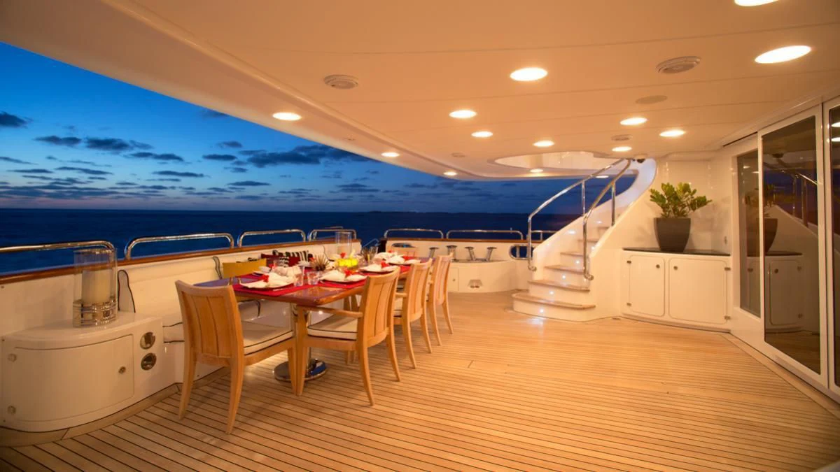 a large room with tables and chairs aboard CHECKMATE Yacht for Charter