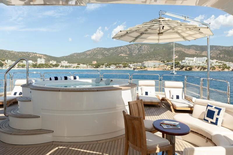 a lounge area with chairs and a table on a boat aboard CHECKMATE Yacht for Charter
