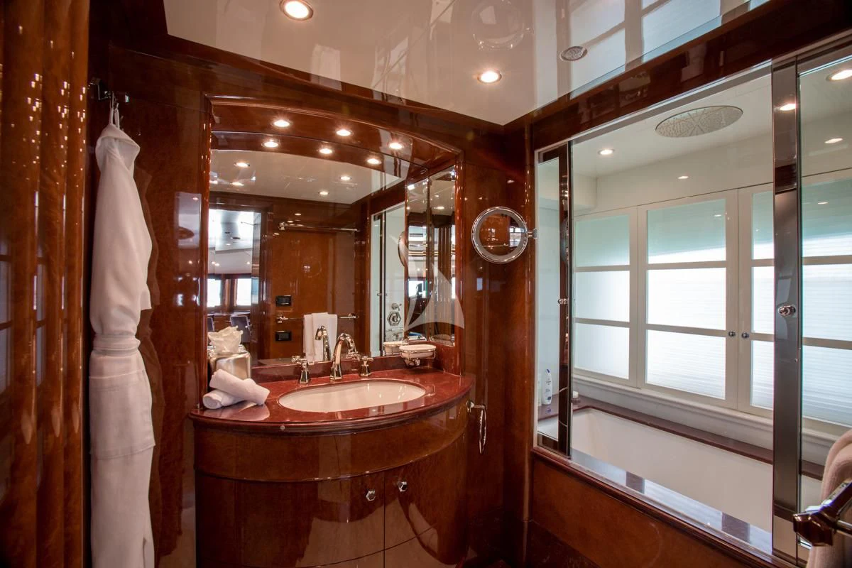 a bathroom with a sink and a large mirror aboard CHECKMATE Yacht for Charter