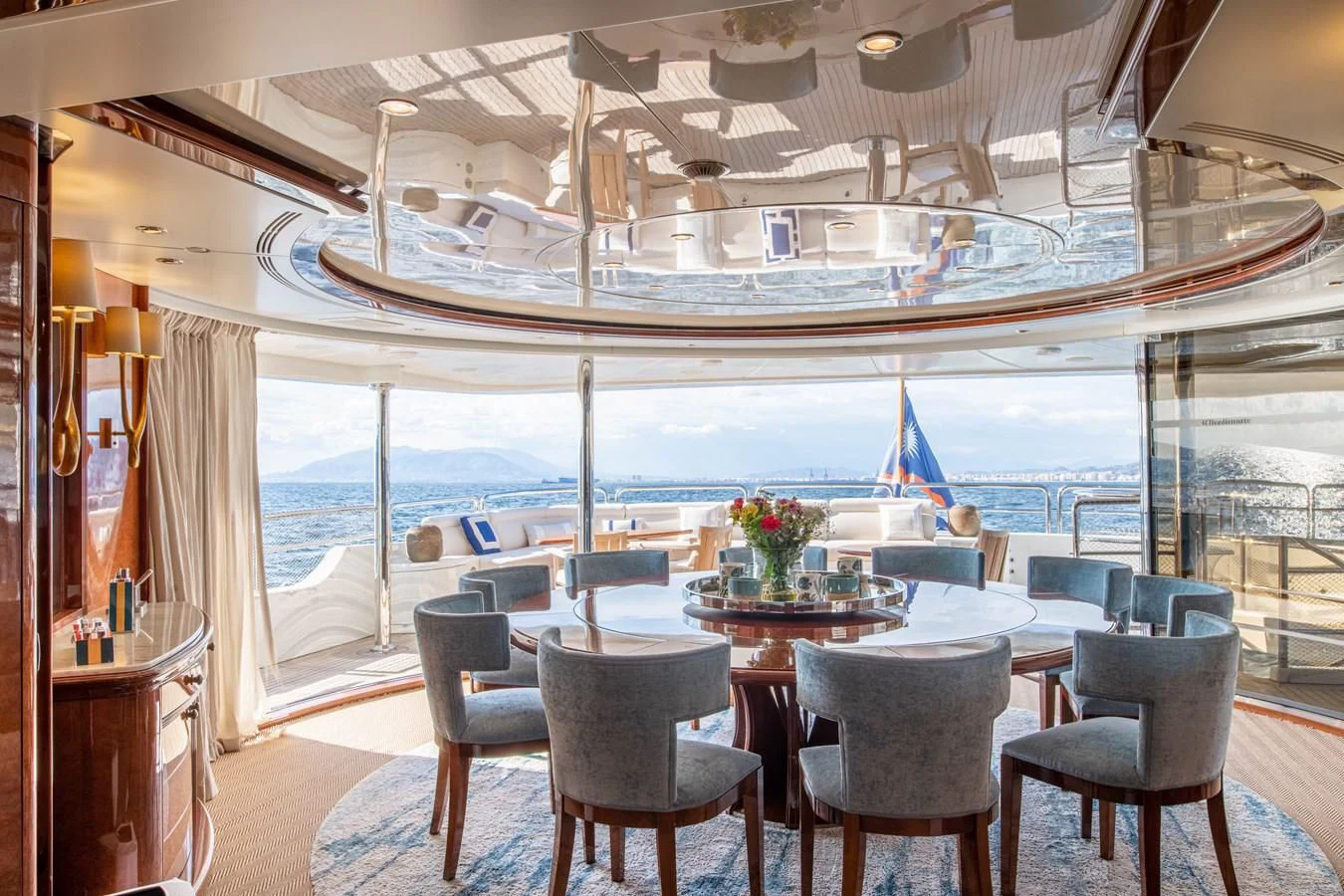 a room with a table chairs and a view of the water aboard CHECKMATE Yacht for Charter