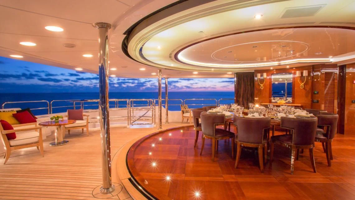 a room with tables and chairs aboard CHECKMATE Yacht for Charter