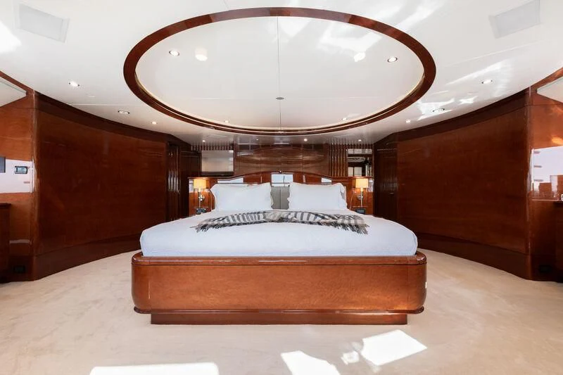 a bed with a round mirror above it aboard CHECKMATE Yacht for Charter