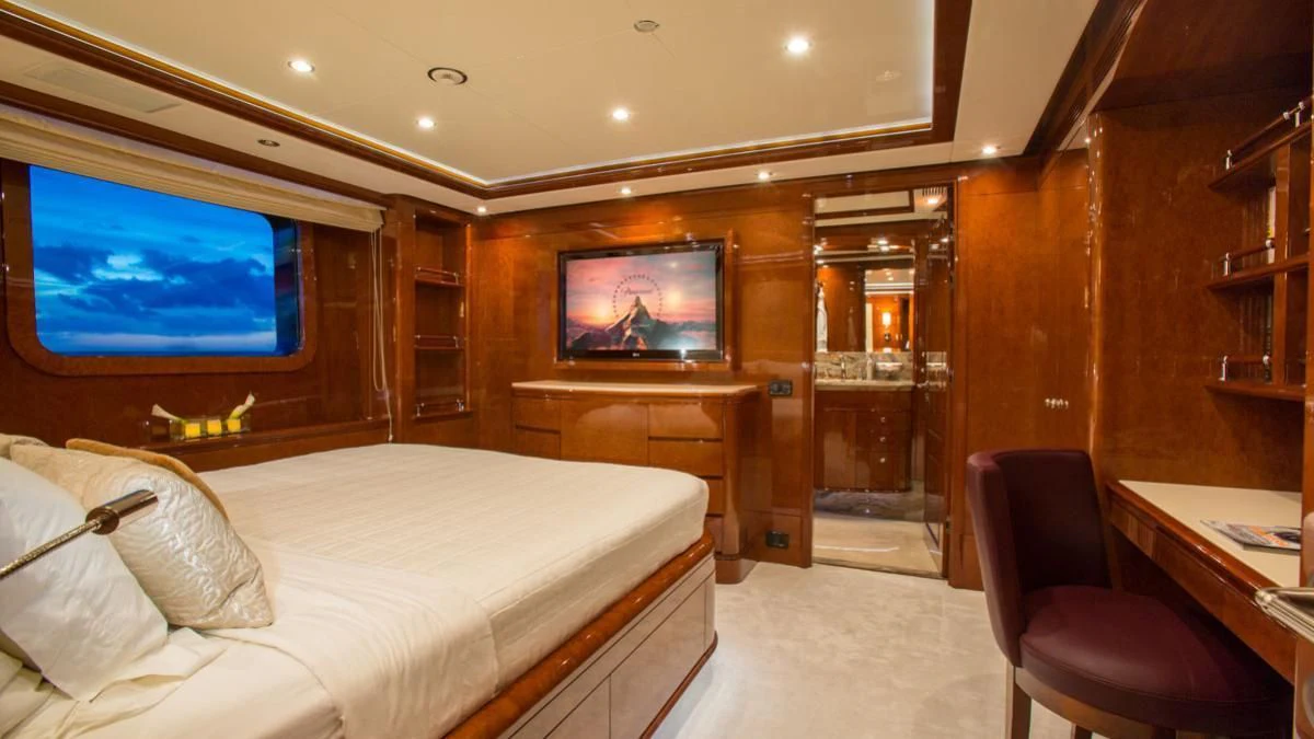 a room with a bed and a tv aboard CHECKMATE Yacht for Charter