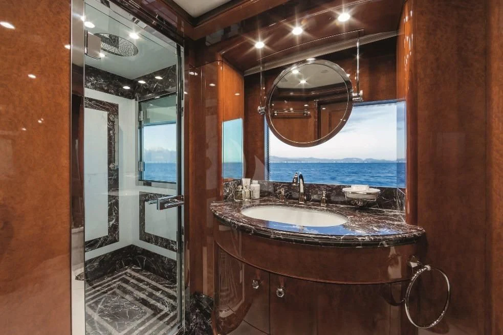 a bathroom with a sink and a mirror aboard CHECKMATE Yacht for Charter