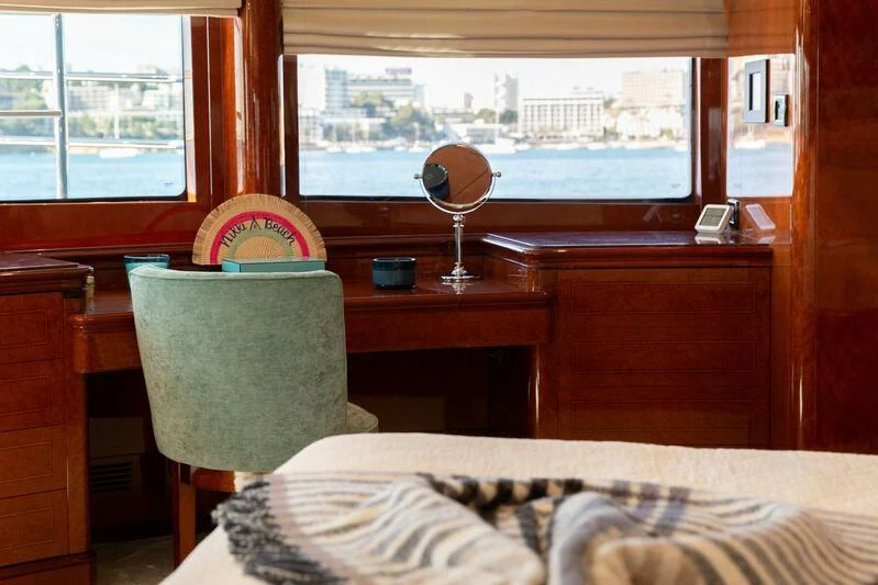 a room with a bed and a fan aboard CHECKMATE Yacht for Charter