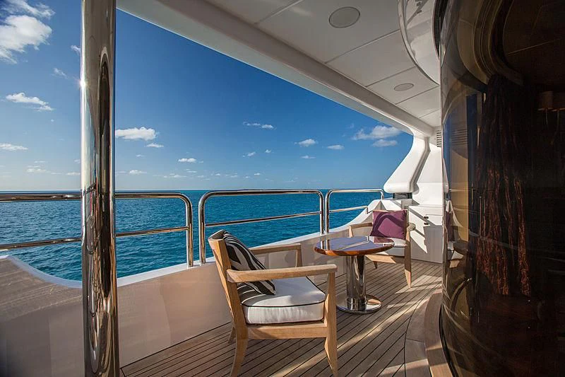 a deck with chairs and a table on it aboard CHECKMATE Yacht for Charter