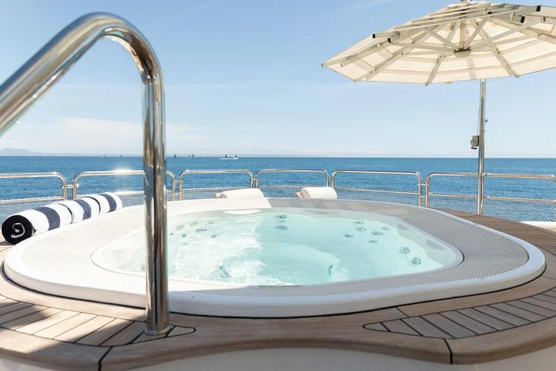a pool with a large umbrella aboard CHECKMATE Yacht for Charter