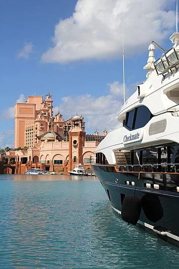 a boat docked in front of a large building aboard CHECKMATE Yacht for Charter