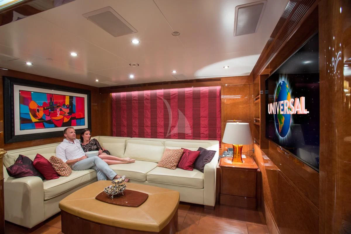 a couple of men sitting on a couch in a living room aboard CHECKMATE Yacht for Charter