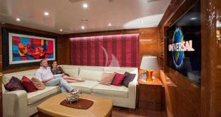 a couple of men sitting on a couch in a living room aboard CHECKMATE Yacht for Charter