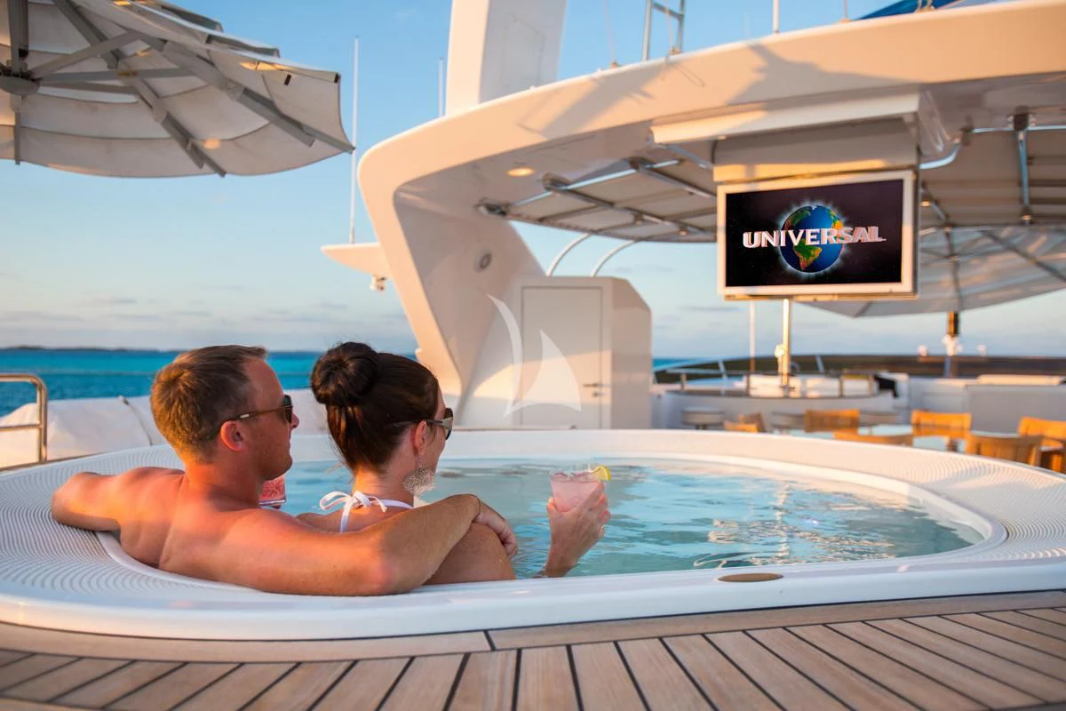 a man and woman kissing in a swimming pool aboard CHECKMATE Yacht for Charter