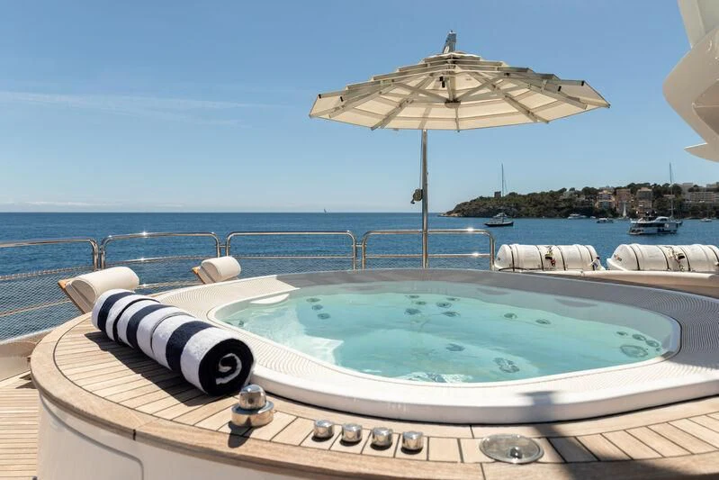 a pool with an umbrella aboard CHECKMATE Yacht for Charter