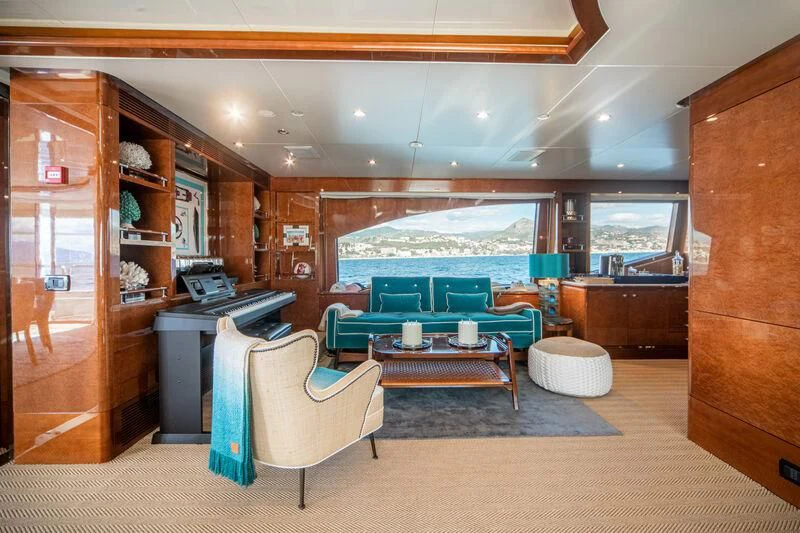 a room with a pool table and chairs aboard CHECKMATE Yacht for Charter