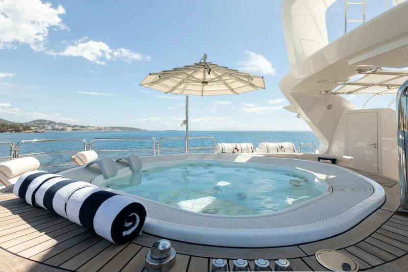 a pool with umbrellas and chairs aboard CHECKMATE Yacht for Charter