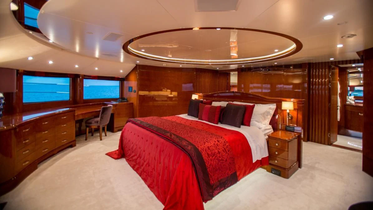 a room with a bed and a desk aboard CHECKMATE Yacht for Charter